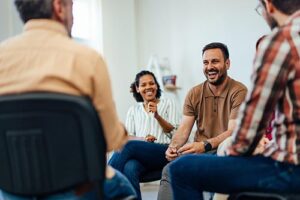 People sitting in a circle at a substance use treatment session