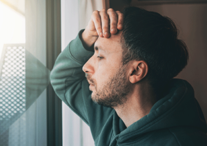 Person looking out window and thinking about fentanyl addiction treatment
