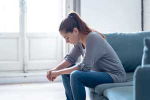 Person sitting alone while thinking about prescription drug addiction treatment