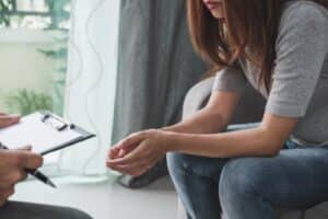 Person going through addiction treatment FAQs with their therapist